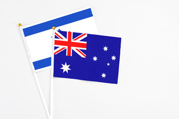 Fototapeta premium Australia and Israel stick flags on white background. High quality fabric, miniature national flag. Peaceful global concept.White floor for copy space.