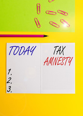 Handwriting text writing Tax Amnesty. Conceptual photo limitedtime opportunity for specified group of taxpayers to pay Blank squared notebook pencil marker paper sheet plain colored background