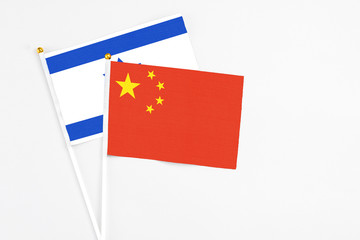 China and Israel stick flags on white background. High quality fabric, miniature national flag. Peaceful global concept.White floor for copy space.