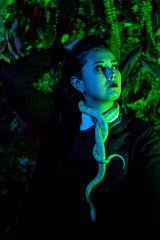 Beautiful Asian woman in rehearsal with snakes