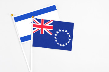 Cook Islands and Israel stick flags on white background. High quality fabric, miniature national flag. Peaceful global concept.White floor for copy space.