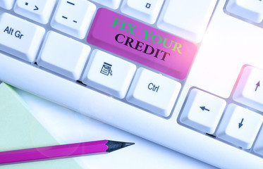 Writing note showing Fix Your Credit. Business concept for Keep balances low on credit cards and other credit White pc keyboard with note paper above the white background