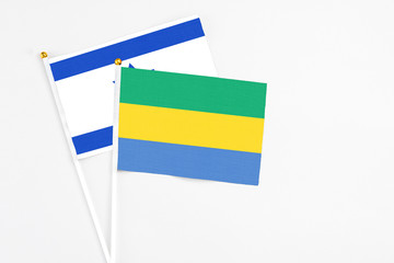 Gabon and Israel stick flags on white background. High quality fabric, miniature national flag....
