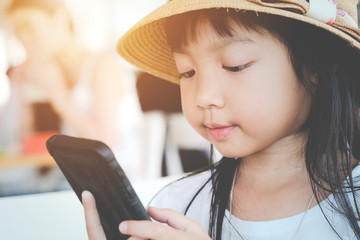 Asian child girls are addictive playing mobile phones, Game Addiction