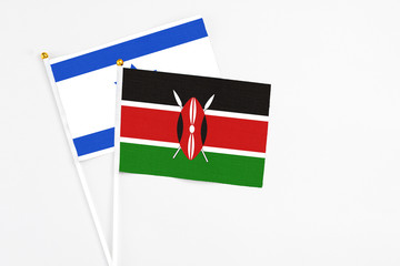 Kenya and Israel stick flags on white background. High quality fabric, miniature national flag. Peaceful global concept.White floor for copy space.