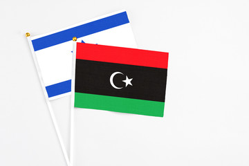 Libya and Israel stick flags on white background. High quality fabric, miniature national flag....