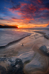 Amazing sunset moment at Pantai Cenang, Langkawi Island Kedah with beautiful sand texture. Malaysia. Long exposure.