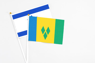 Saint Vincent And The Grenadines and Israel stick flags on white background. High quality fabric,...