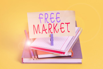 Conceptual hand writing showing Free Market. Concept meaning an unregulated system of economic exchange or free competition Book pencil rectangle shaped reminder notebook clothespins