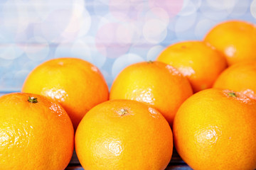 Creative flat lay top view of fresh orange fruit on blue wooden background with copy space. fresh citrus mock up