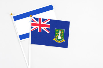 Fototapeta premium British Virgin Islands and Israel stick flags on white background. High quality fabric, miniature national flag. Peaceful global concept.White floor for copy space.