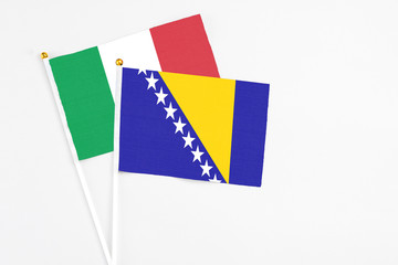 Bosnia Herzegovina and Italy stick flags on white background. High quality fabric, miniature...