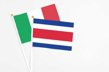 Costa Rica and Italy stick flags on white background. High quality fabric, miniature national flag. Peaceful global concept.White floor for copy space.