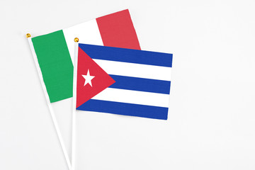 Cuba and Italy stick flags on white background. High quality fabric, miniature national flag. Peaceful global concept.White floor for copy space.