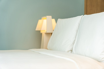 Pillow and blanket on bed with light lamp decoration interior