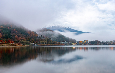 Calm and tranquil scene of mt.Fuji under cloudy sky and fog in the morning , View from Kawaguchiko lake , Yamanashi , Japan