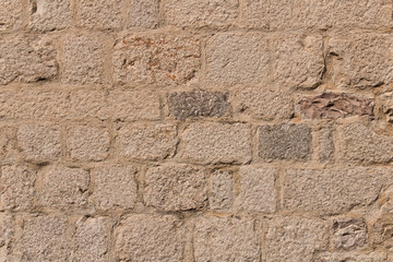 Background texture of the old fortress stone wall. Conceptual background for designers. Selective focus.