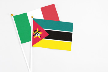 Mozambique and Italy stick flags on white background. High quality fabric, miniature national flag....