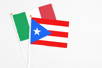 Puerto Rico and Italy stick flags on white background. High quality fabric, miniature national flag. Peaceful global concept.White floor for copy space.