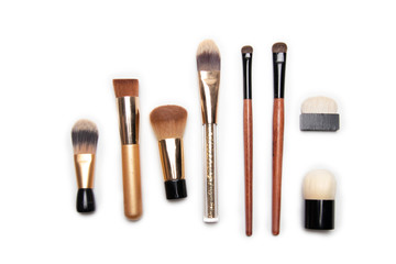 Different makeup brushes isolated on white background