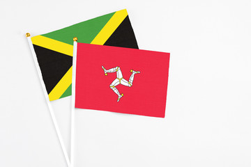 Isle Of Man and Jamaica stick flags on white background. High quality fabric, miniature national...