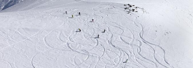 Snowboarder downhill on off piste slope with newly-fallen snow