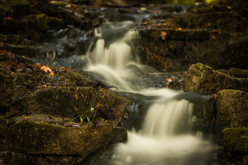 Fototapeta na wymiar Small Cascading Waterfall in the Forest