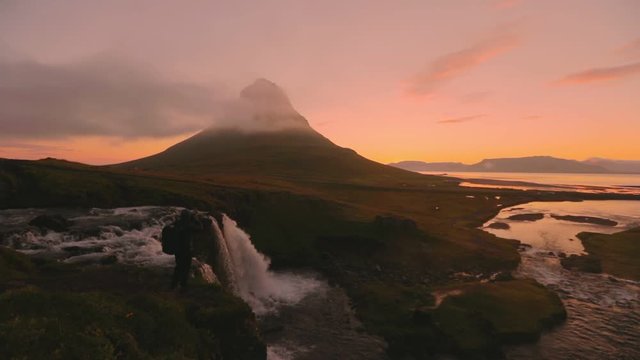 Scene video of photographer shoot Kirkjufellsfoss waterfall in the morning , Summer in Iceland, concept of travel	