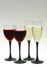 Two glasses with red wine and two glasses with champagne