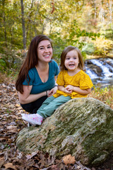 mother and child in front of waterfall