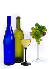 Glass of wine, a bottle and grapes on a white background. Isolated on white.