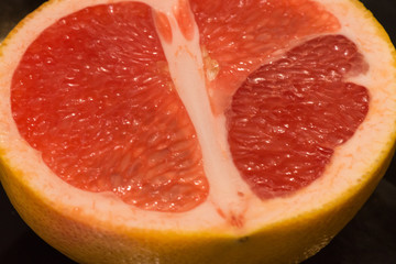Half a grapefruit on black background