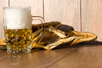 Oktoberfest holiday concept. Smoked fish and a glass of beer. Cold smoked pike perch on a dark rustic background.