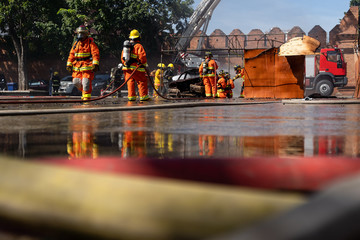 Firefighters are fighting fire with a fire brigade, Firefighters fighting fire during training with...