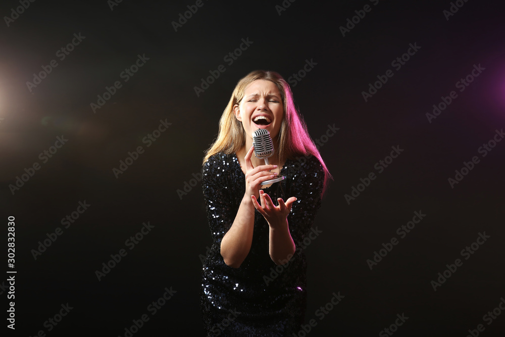 Poster beautiful young female singer with microphone on stage