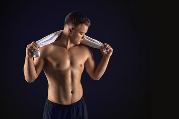 Fototapeta na wymiar Handsome male bodybuilder on dark background