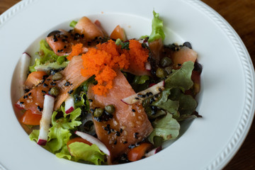 Salmon Salad with dressing salad with greenoak, Olive, tomatoes. Home made food. Concept for a tasty and healthy meal.  Top view. Close up.