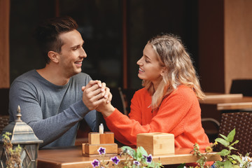 Fototapeta premium Happy young couple on romantic date in cafe
