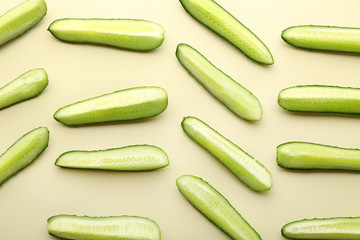 Pieces of fresh cucumbers on light background