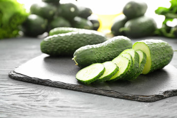 Fresh green cucumbers on slate plate