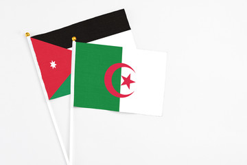 Algeria and Jordan stick flags on white background. High quality fabric, miniature national flag. Peaceful global concept.White floor for copy space.