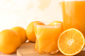 Glass and jug of fresh orange juice on board