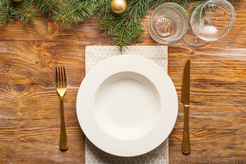 Beautiful table setting for Christmas dinner on wooden background