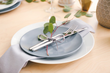 Beautiful table setting with eucalyptus on wooden background