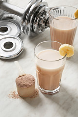 Glasses of protein shake on table