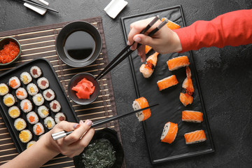 Women eating tasty sushi at table © Pixel-Shot