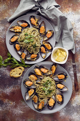 Vertical shot Delicious seafood pasta. Fresh mussels and pesto pasta. Mediterranean Kitchen. Top view