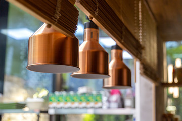 Lamps above a food dispenser in a restaurant. Close-up.