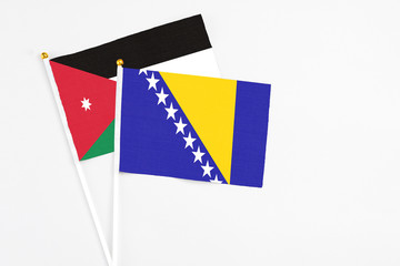 Bosnia Herzegovina and Jordan stick flags on white background. High quality fabric, miniature...