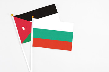 Bulgaria and Jordan stick flags on white background. High quality fabric, miniature national flag. Peaceful global concept.White floor for copy space.